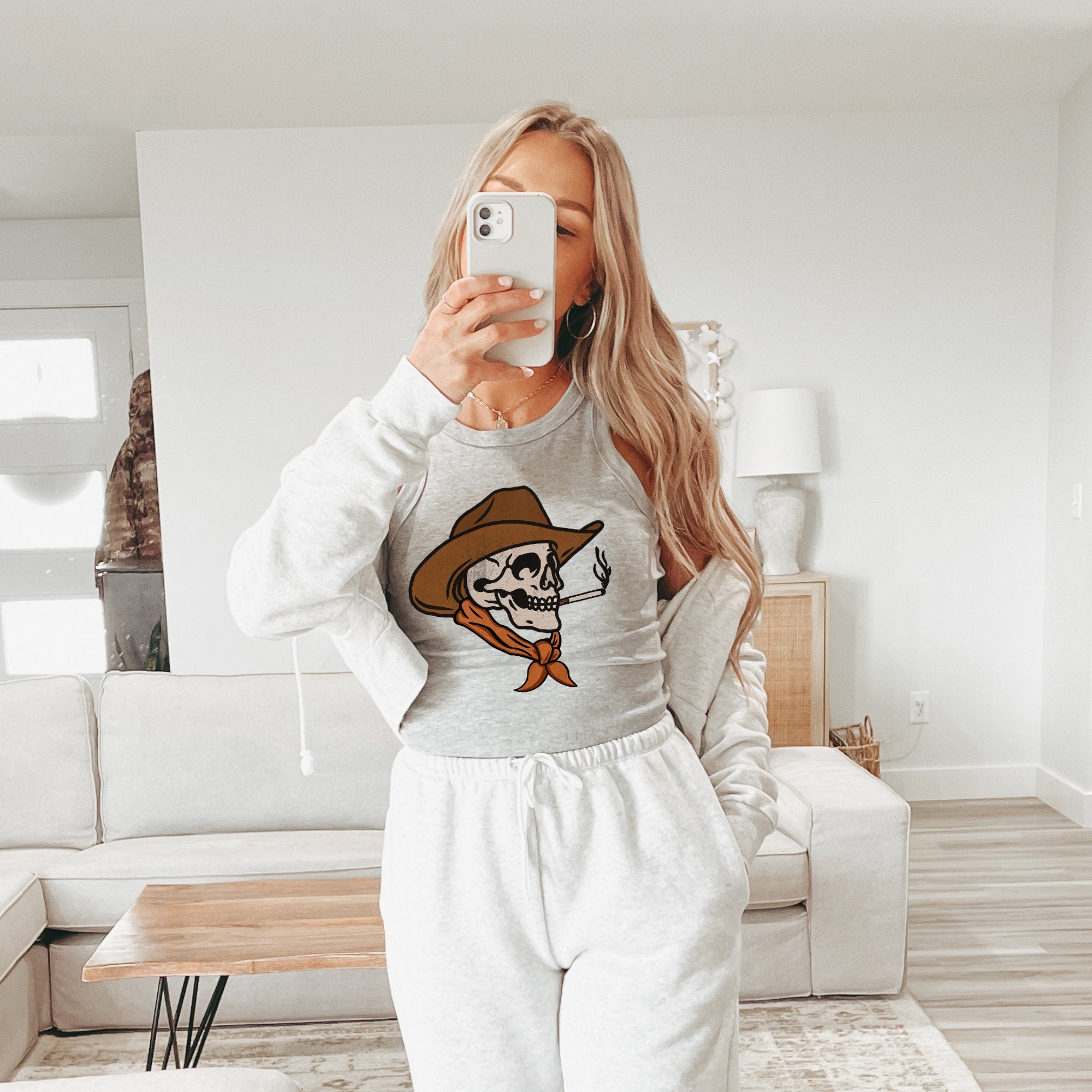 a woman taking a selfie in a living room