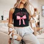 a woman wearing a black shirt with a pink bow