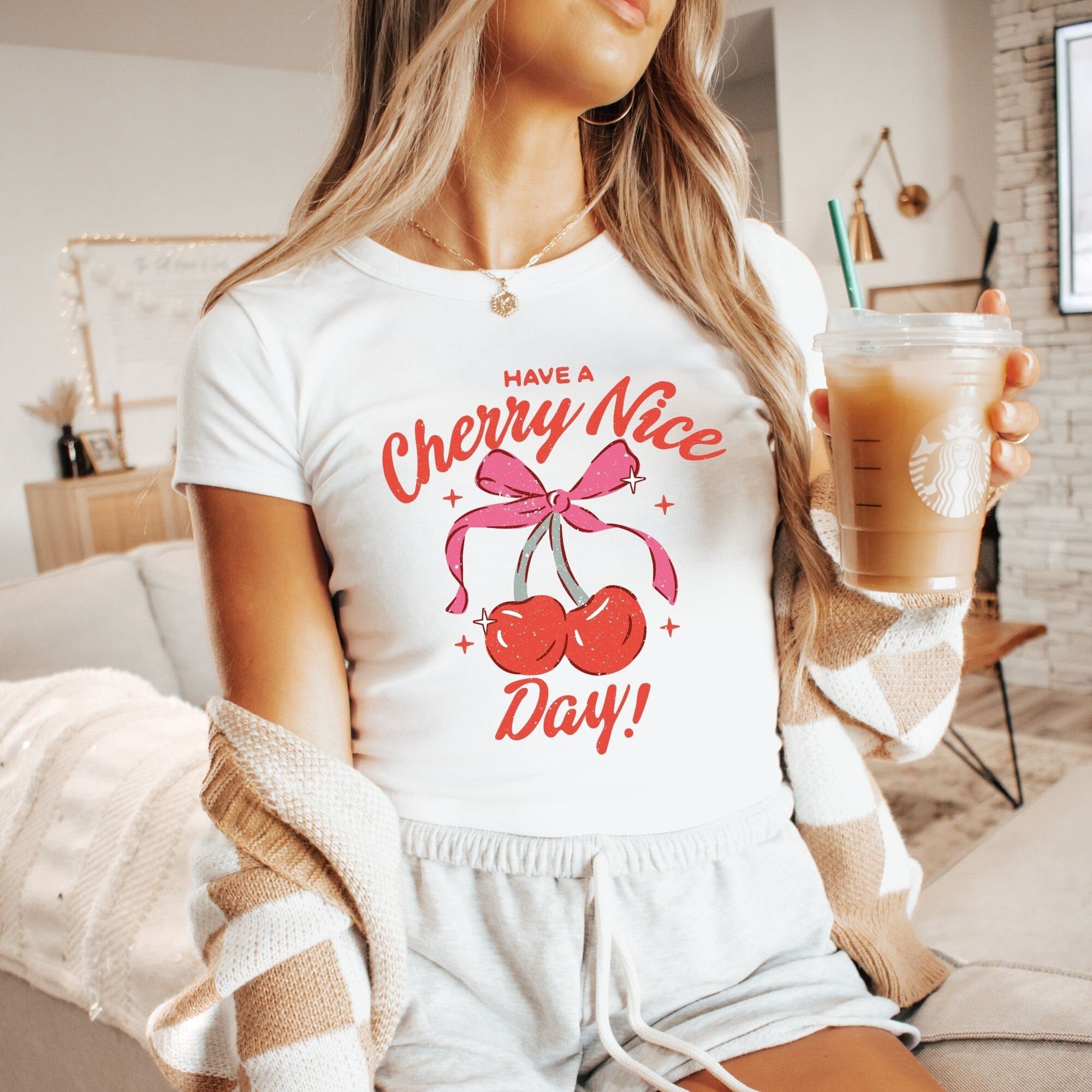 a woman is holding a drink in her hand