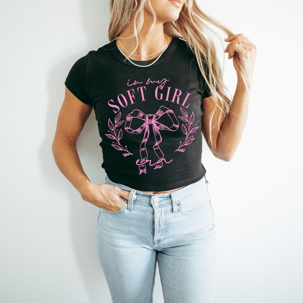 a woman wearing a black shirt and jeans