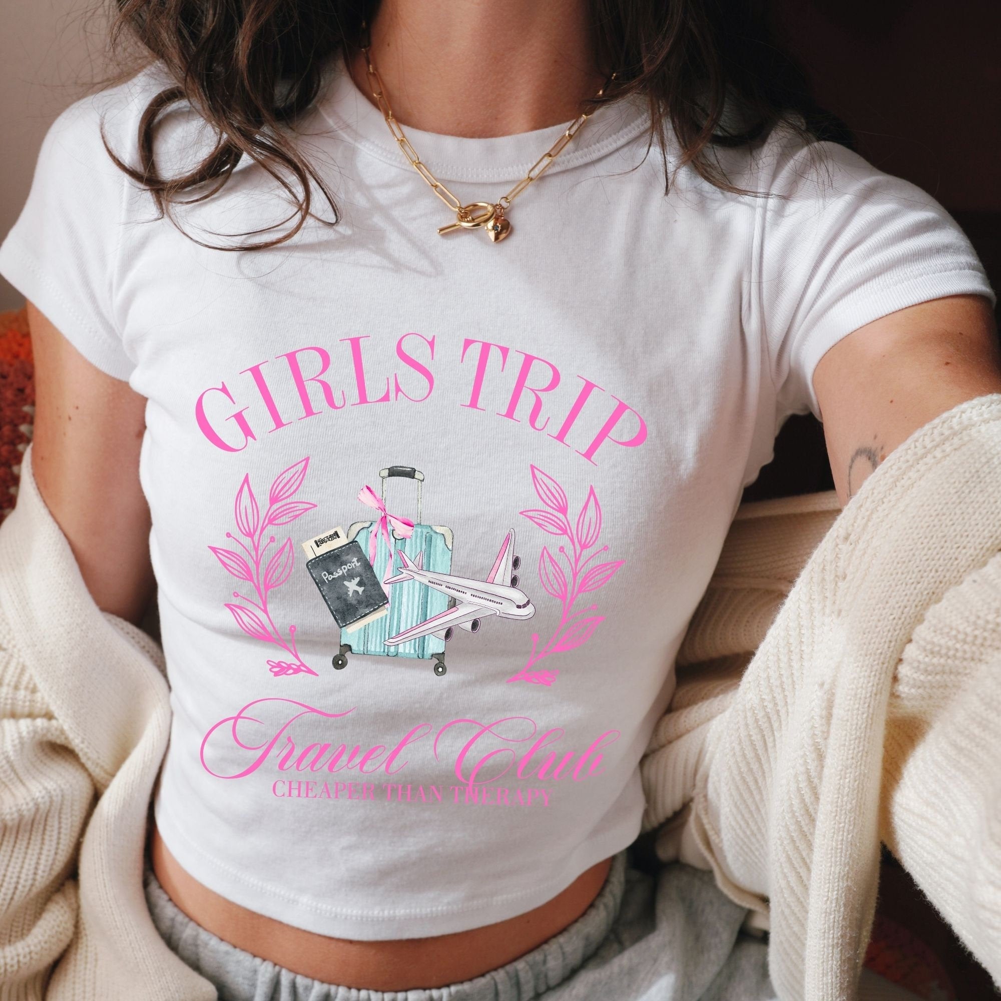 a woman wearing a white shirt with pink lettering on it