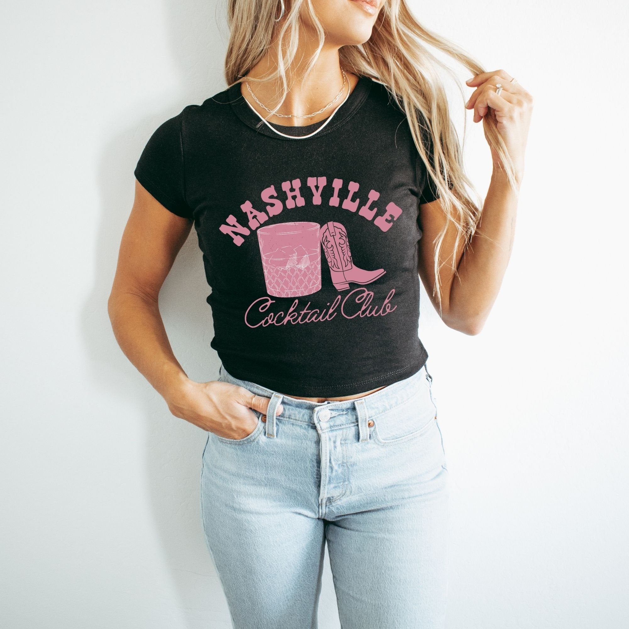 a woman wearing a black shirt and jeans