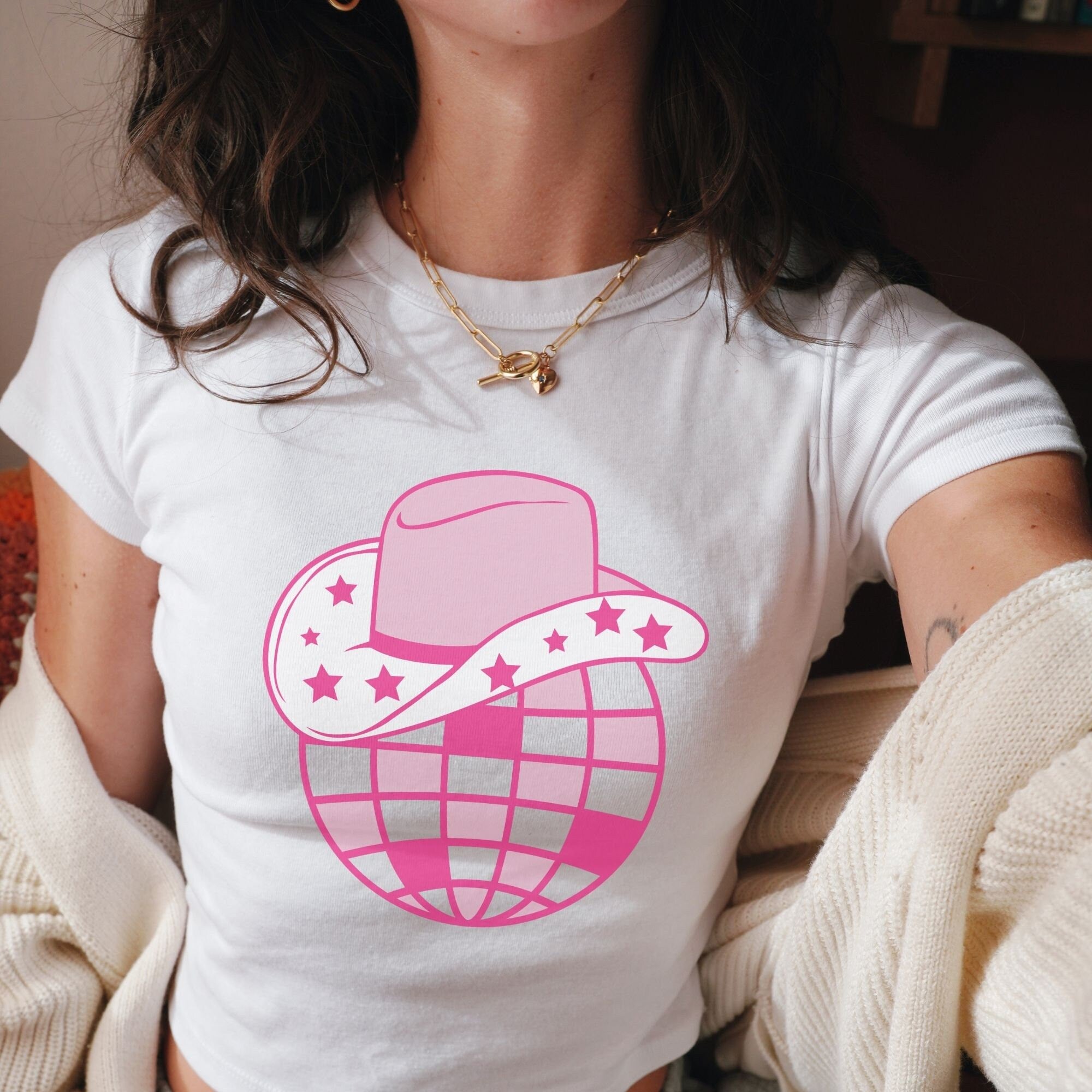 a woman wearing a t - shirt with a hat and stars on it