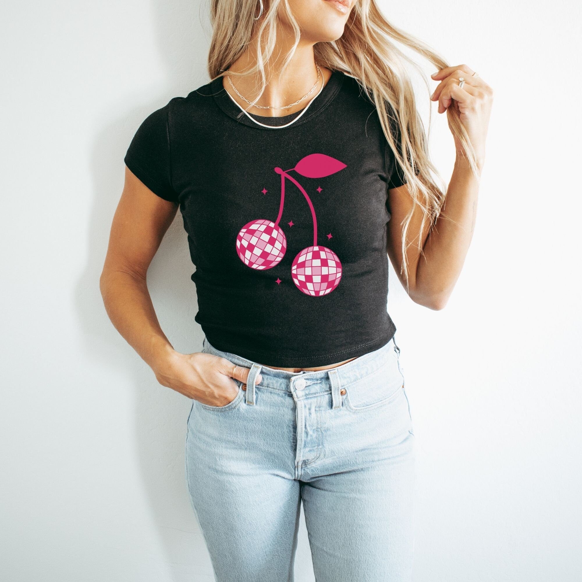 a woman wearing a t - shirt with a cherry on it