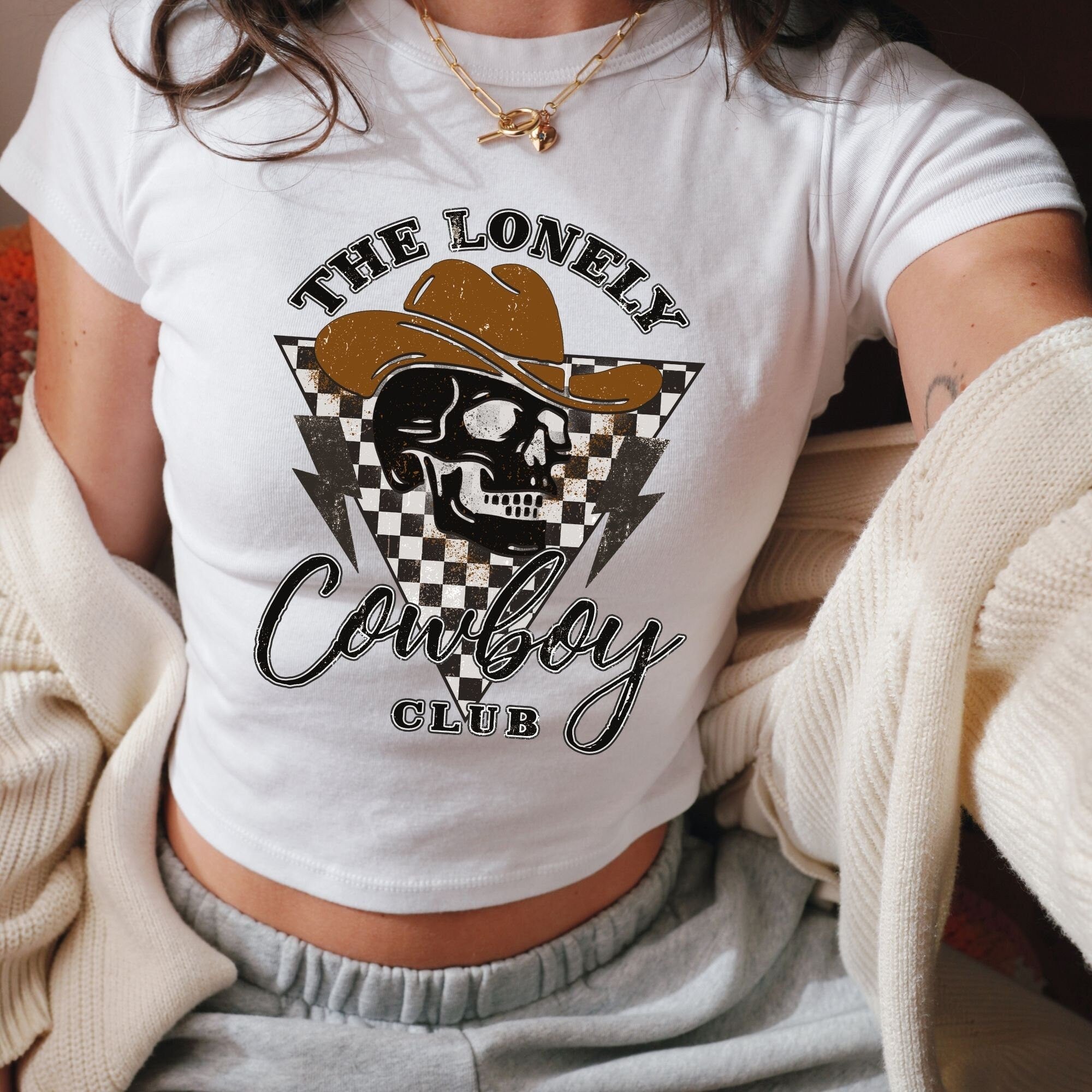 a woman wearing a white shirt with a skull on it