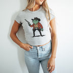a woman wearing a cowboy shirt holding a gun