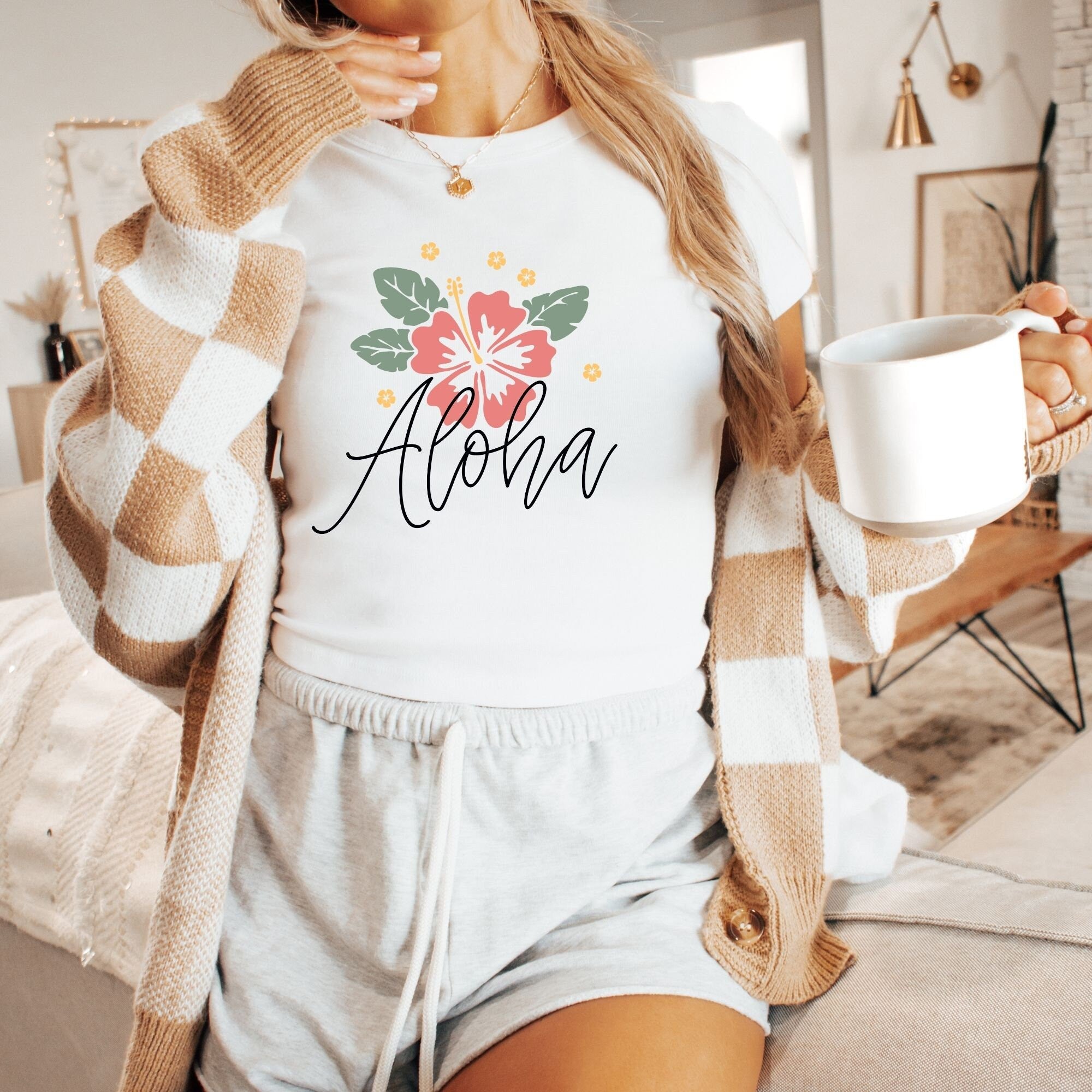 a woman is holding a cup of coffee