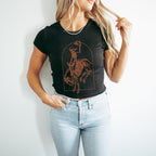 a woman wearing a black shirt with a picture of a cowboy on it