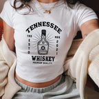 a woman wearing a tennessee whiskey t - shirt