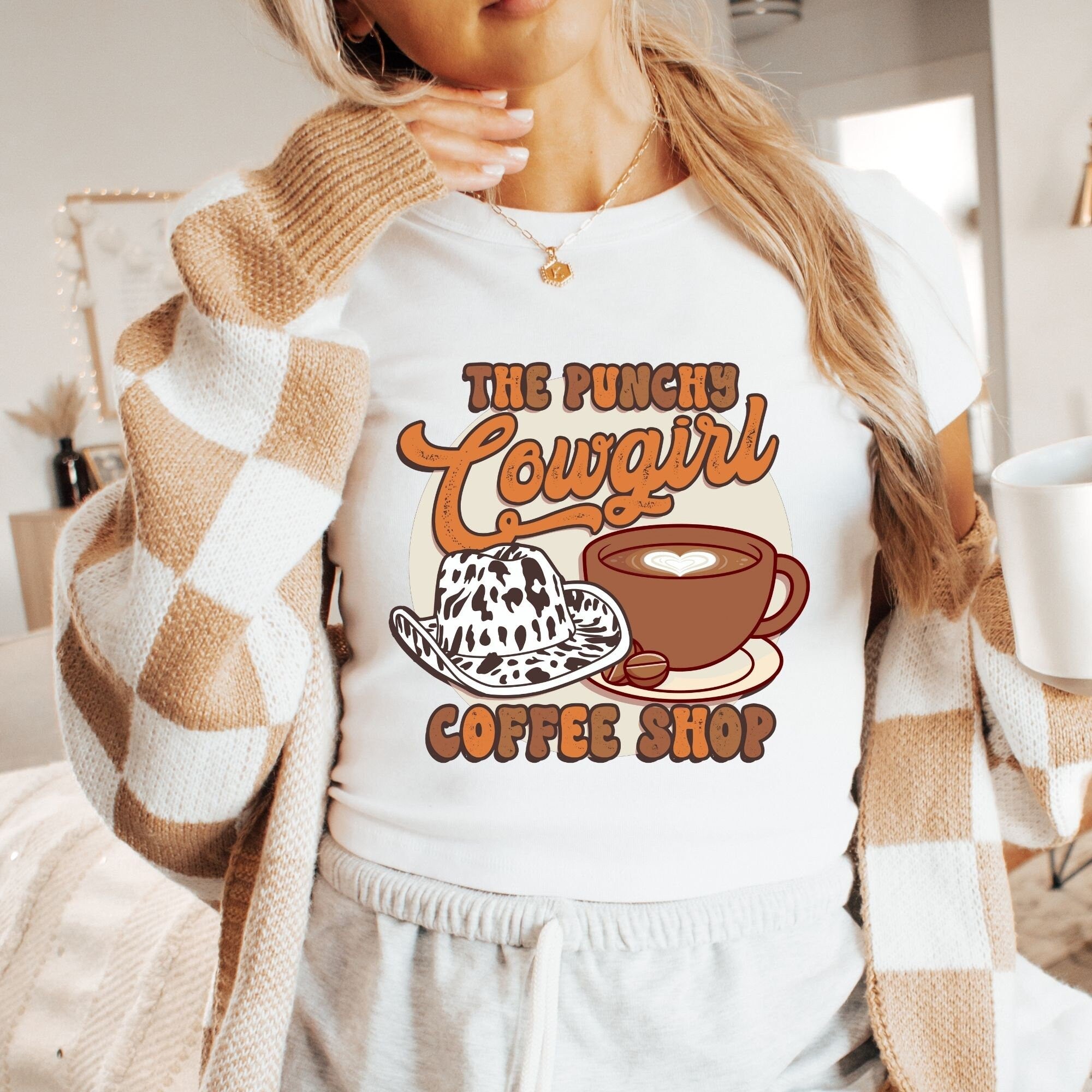a woman wearing a t - shirt that says the punch cougal coffee shop
