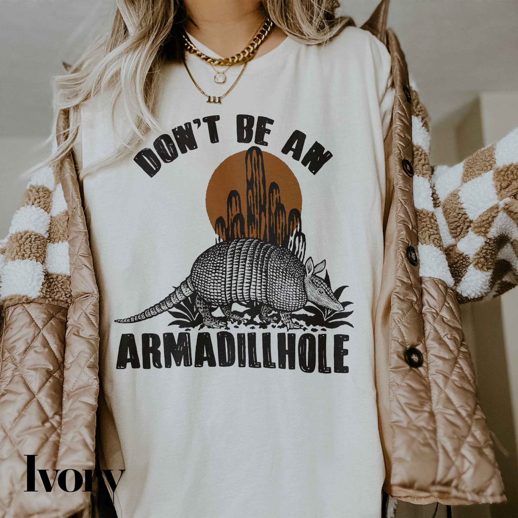 a woman wearing a shirt with a armadilloe on it
