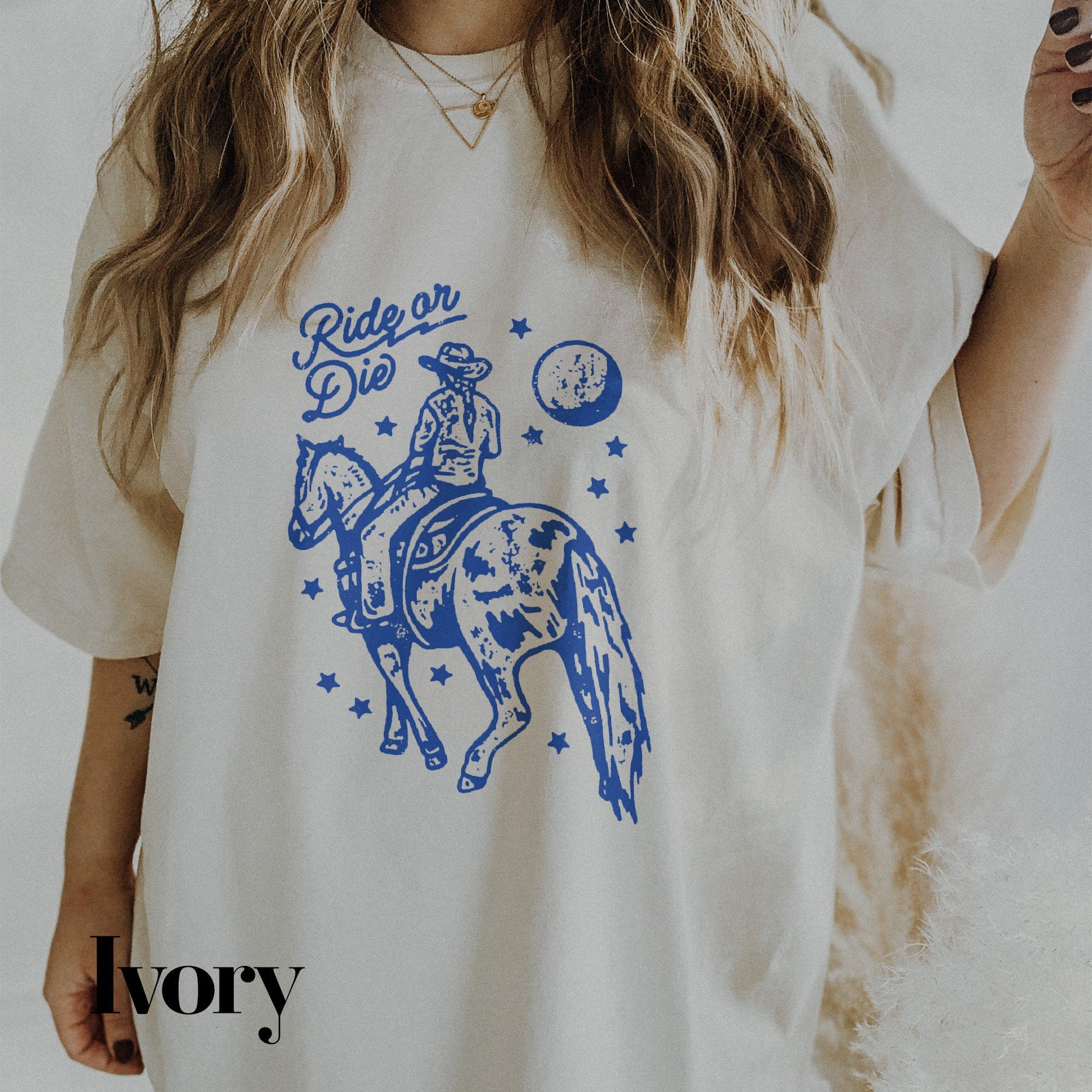 a woman wearing a white shirt with a blue graphic on it