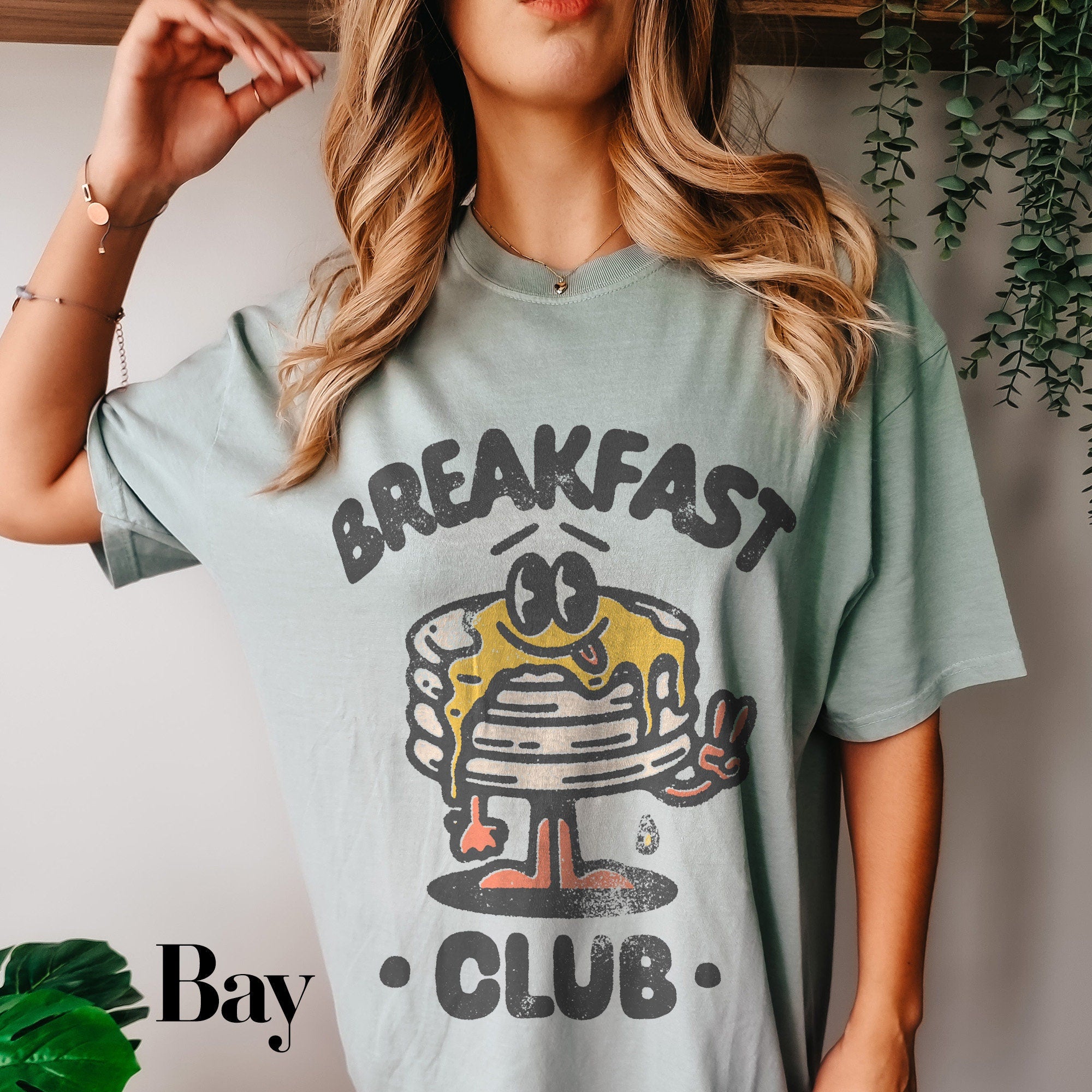 a woman wearing a breakfast club t - shirt