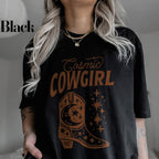 a woman wearing a black t - shirt with the words cosmic cowgirl on it