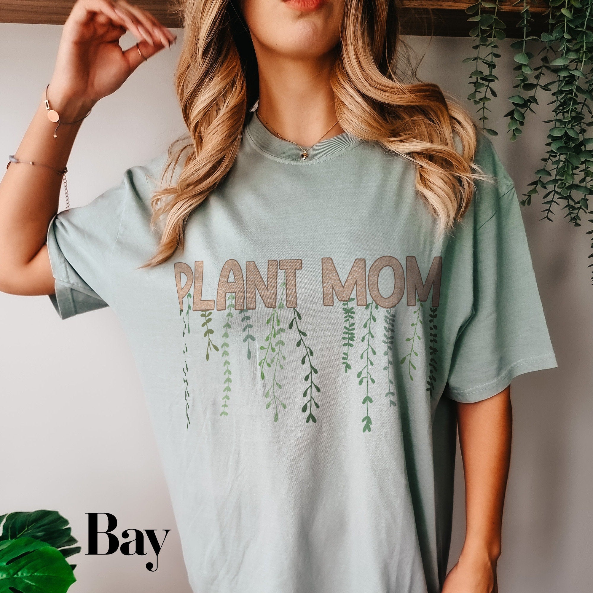 a woman wearing a plant mom t - shirt