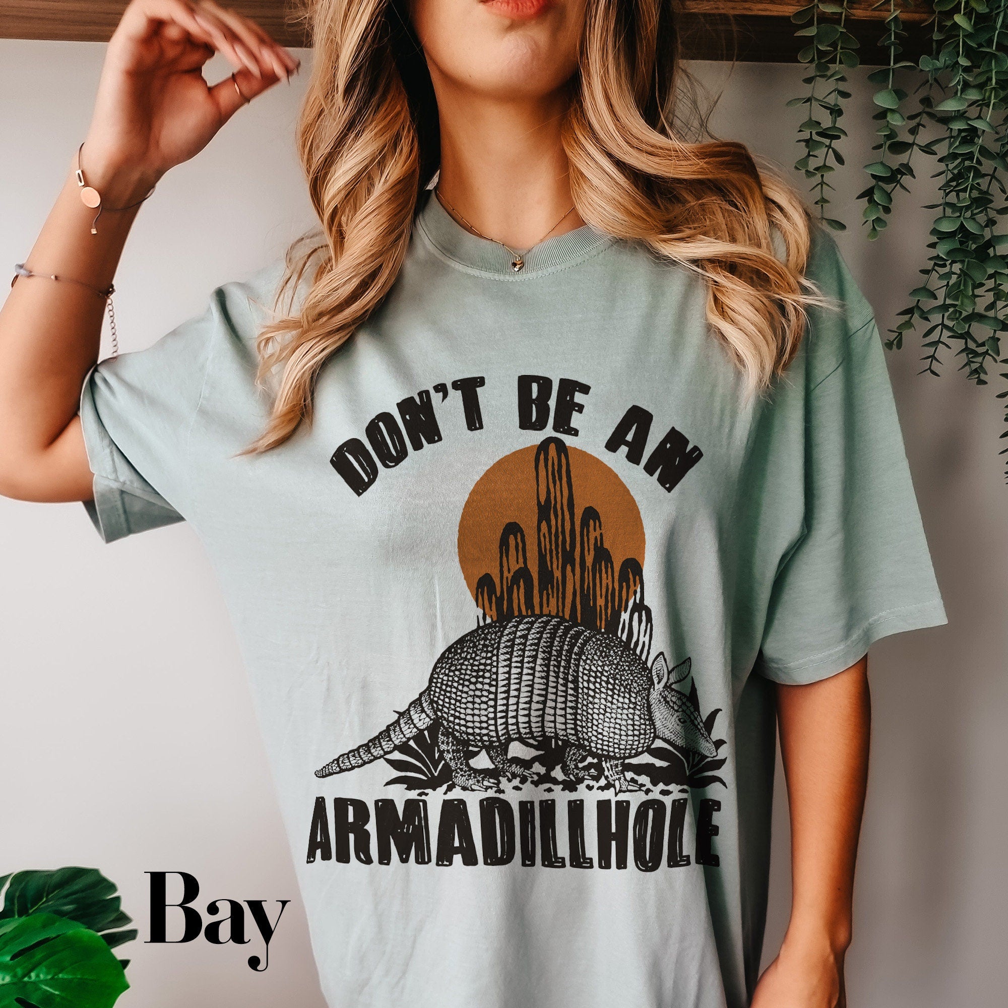 a woman wearing a shirt that says don&#39;t be an armadillole