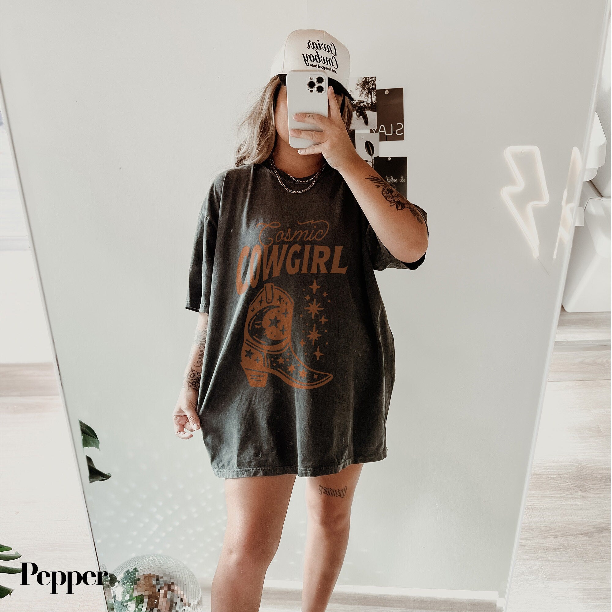 a woman taking a selfie in front of a mirror