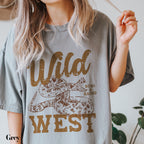 a woman holding a cigarette and wearing a wild west t - shirt