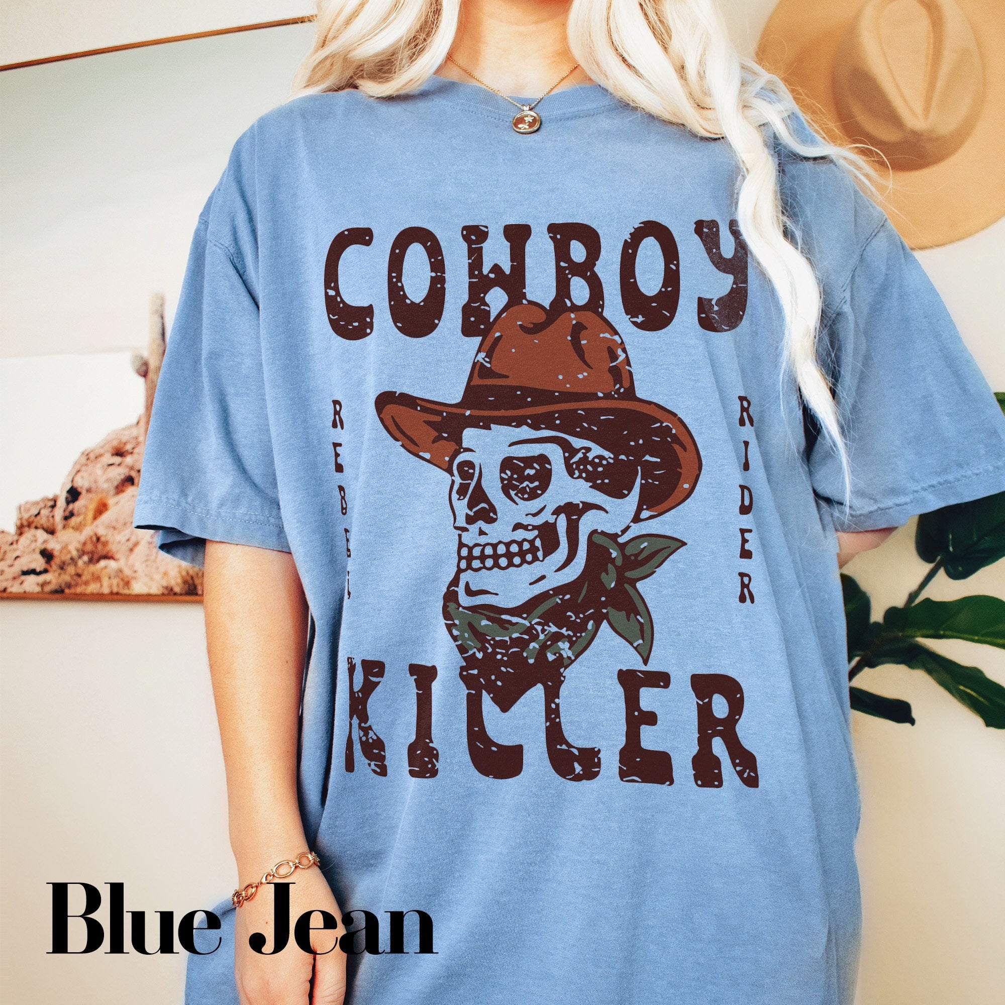 a woman wearing a cowboy shirt with a skull on it