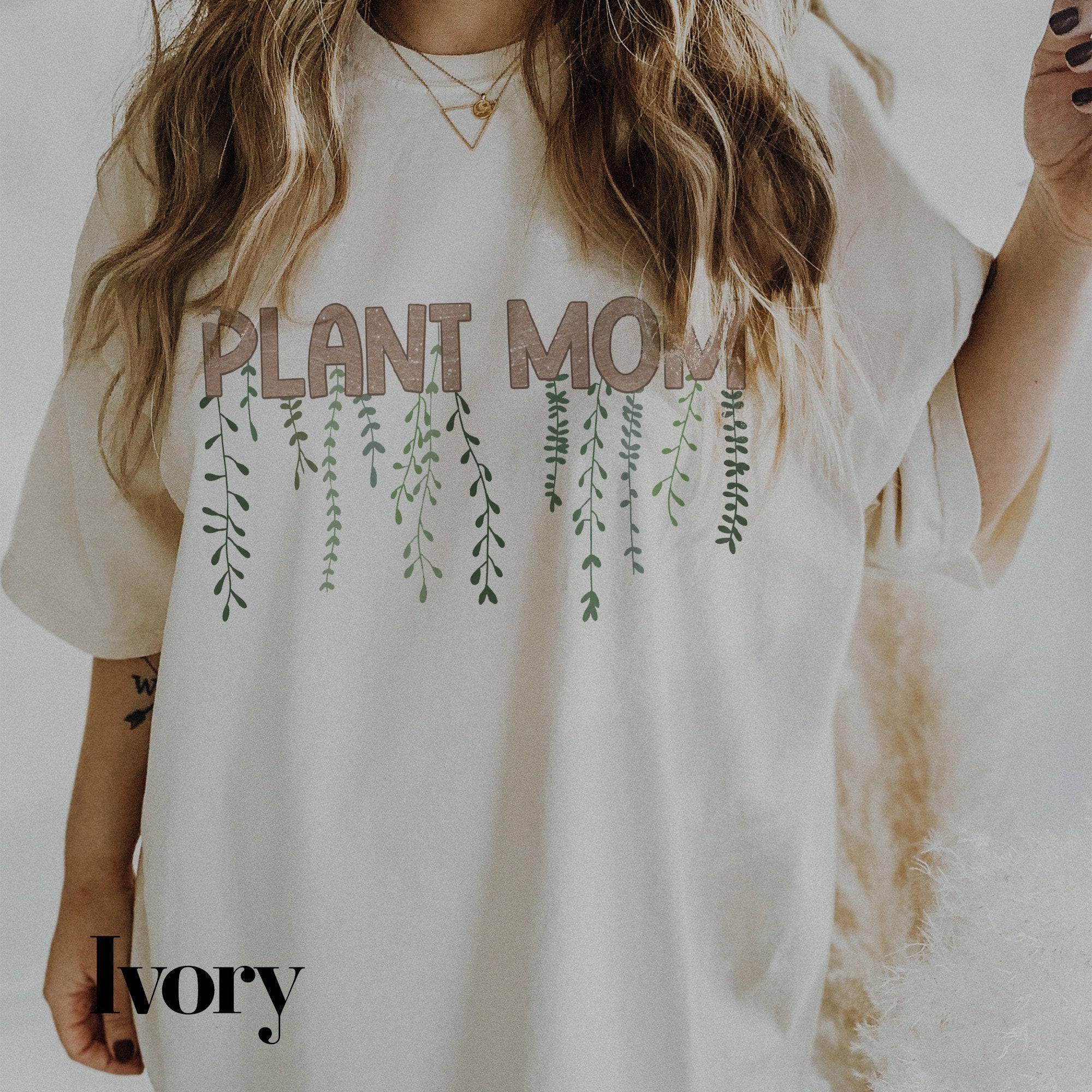 a woman wearing a plant mom t - shirt
