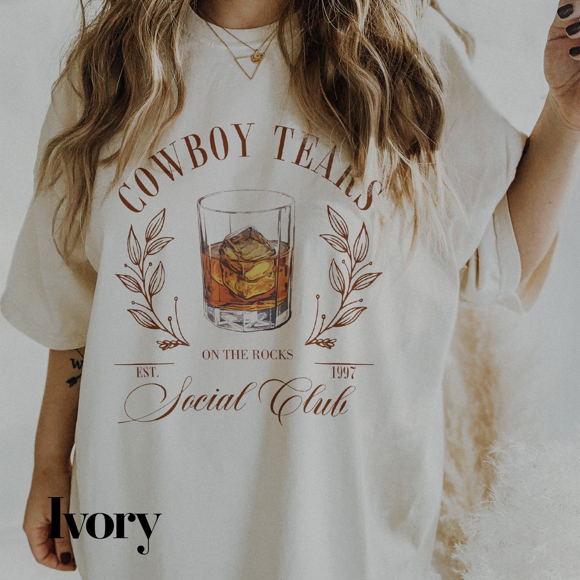 a woman wearing a cowboy tears t - shirt holding a cigar