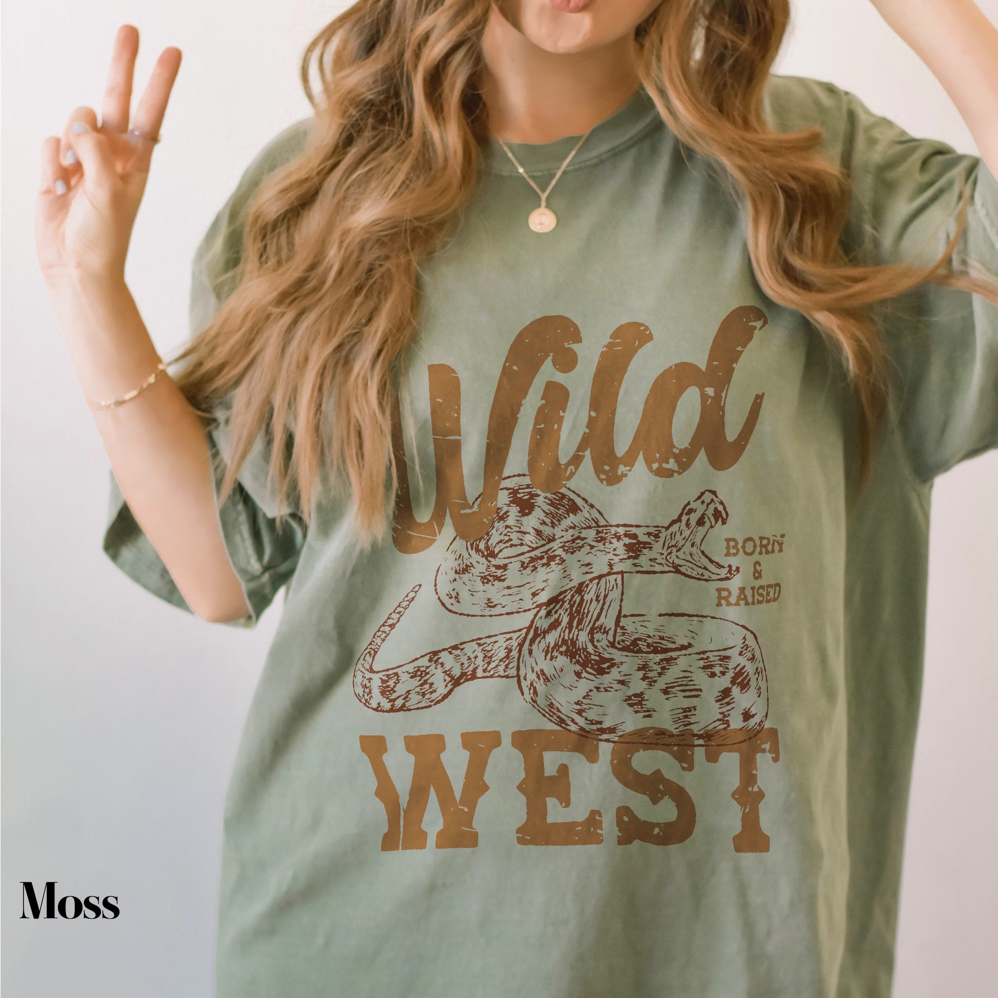 a woman with long hair wearing a wild west t - shirt