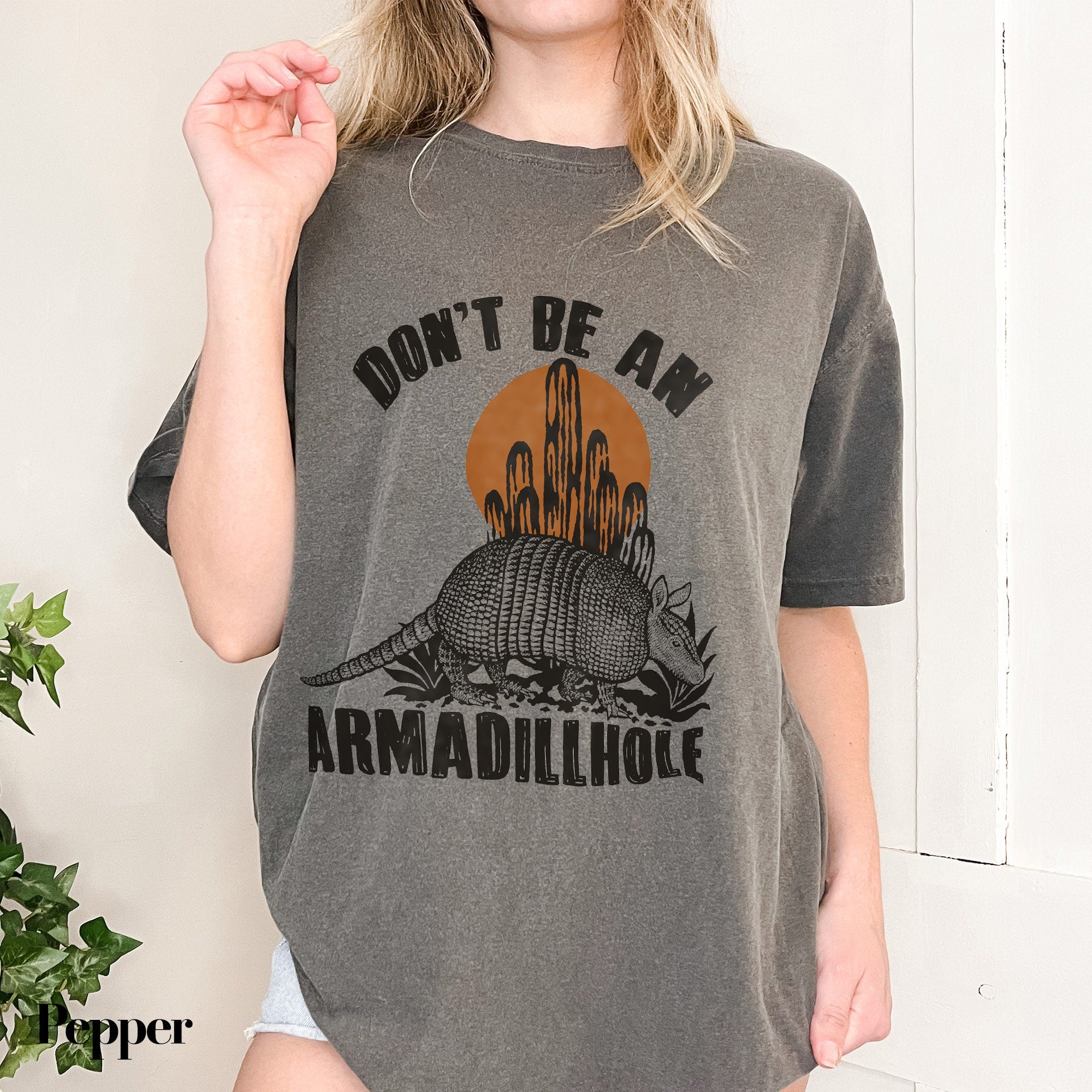a woman wearing a shirt that says don&#39;t be an armadilloise