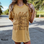 a woman wearing a t - shirt with a picture of a giraffe on