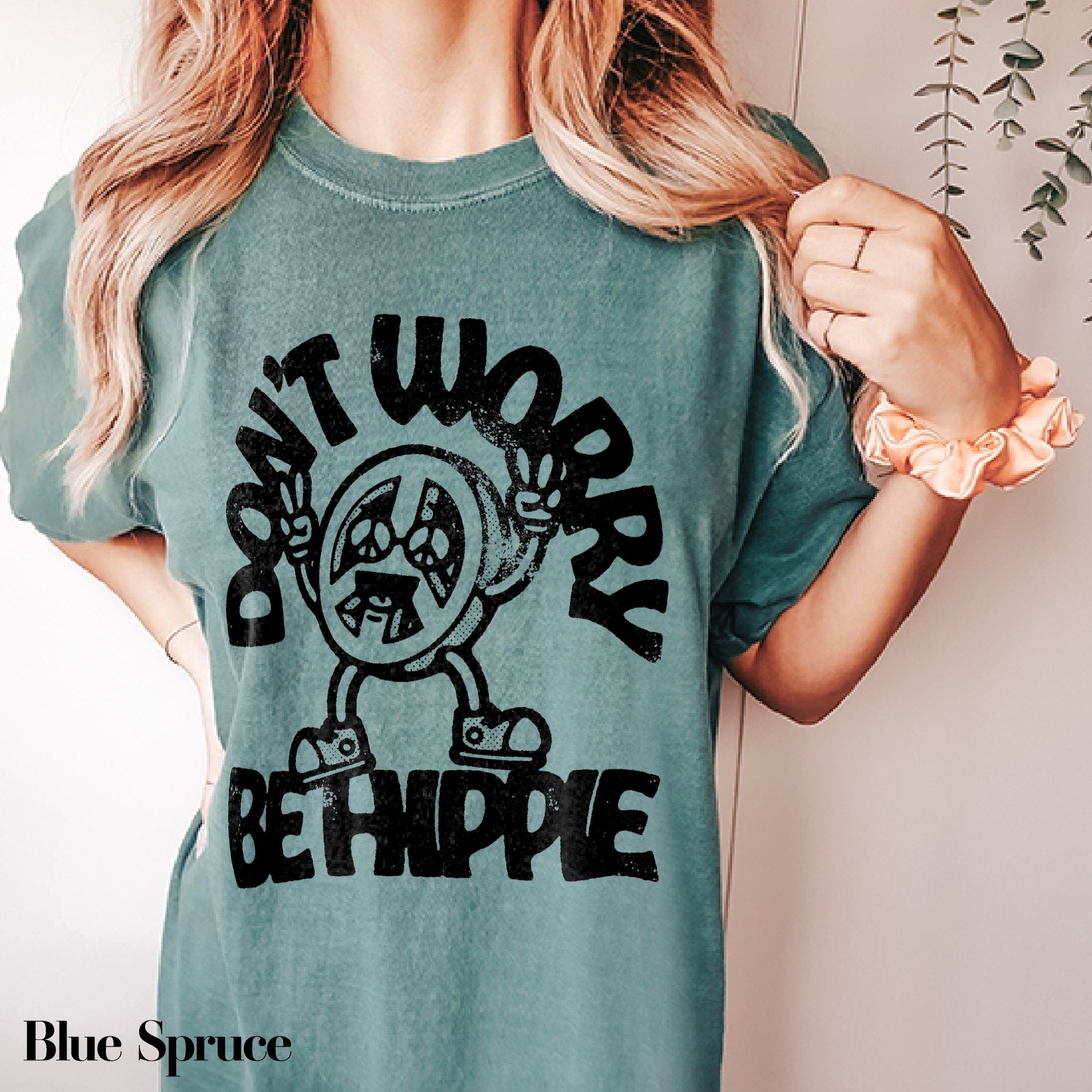 a woman wearing a t - shirt that says don&#39;t work be hippie