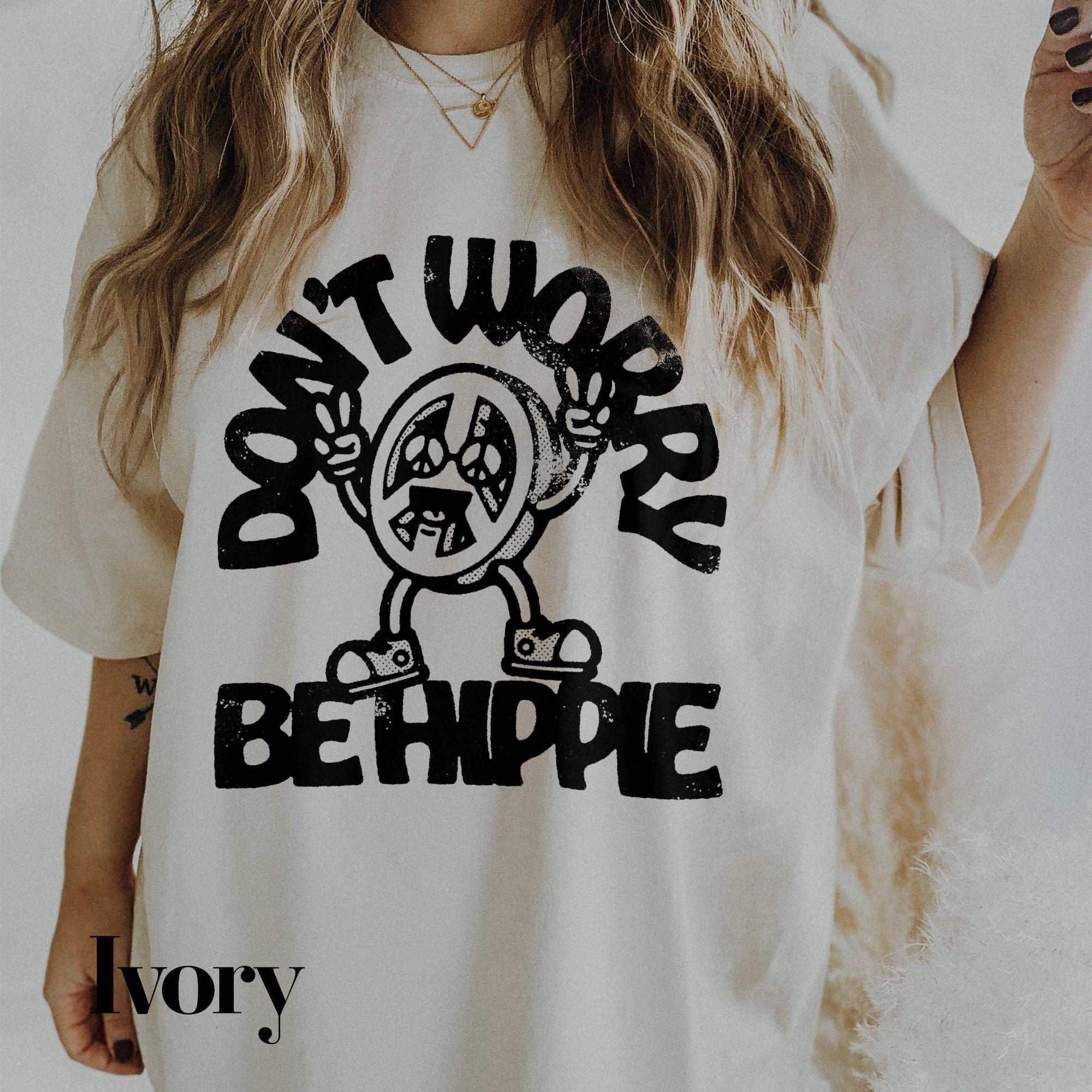 a woman wearing a t - shirt that says don&#39;t work be hippie