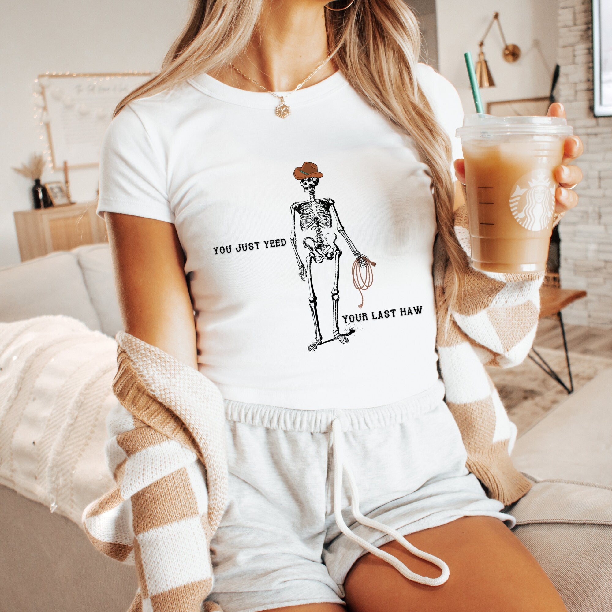a woman sitting on a couch holding a drink