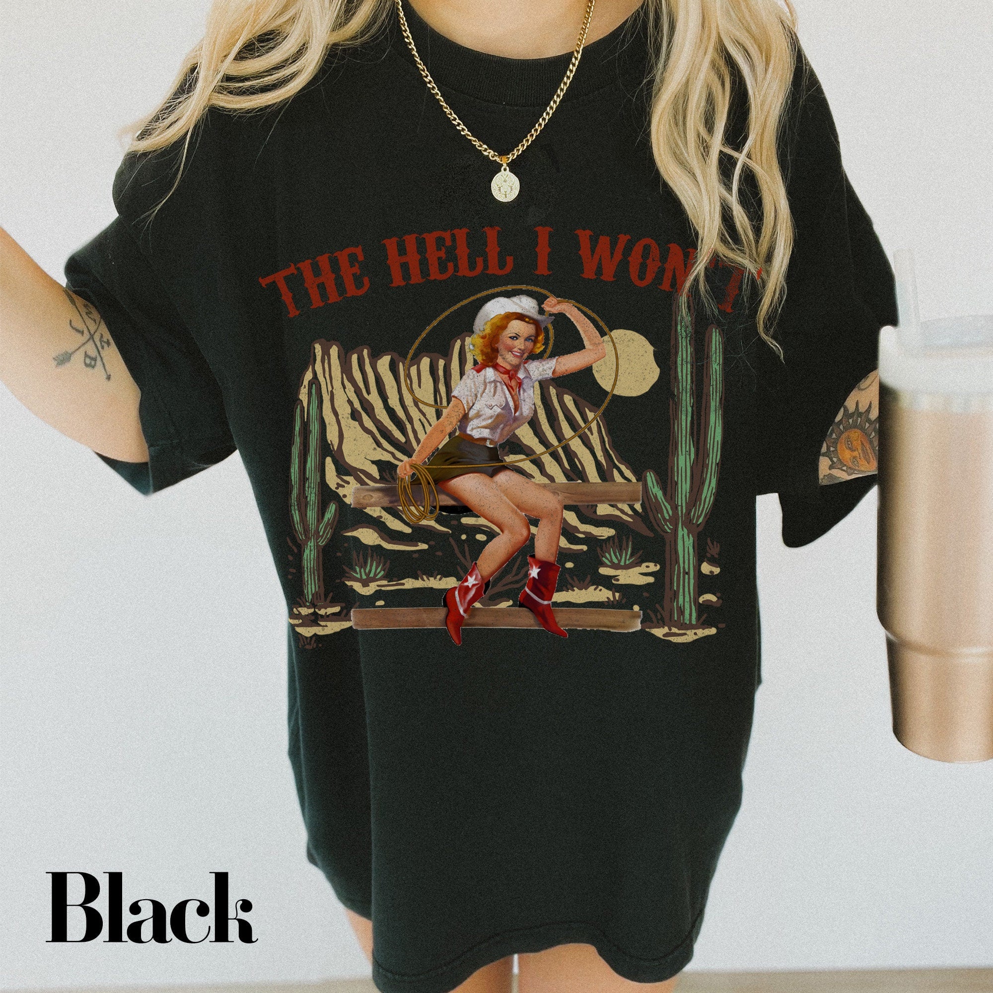 a woman wearing a black t - shirt with a picture of a woman holding a