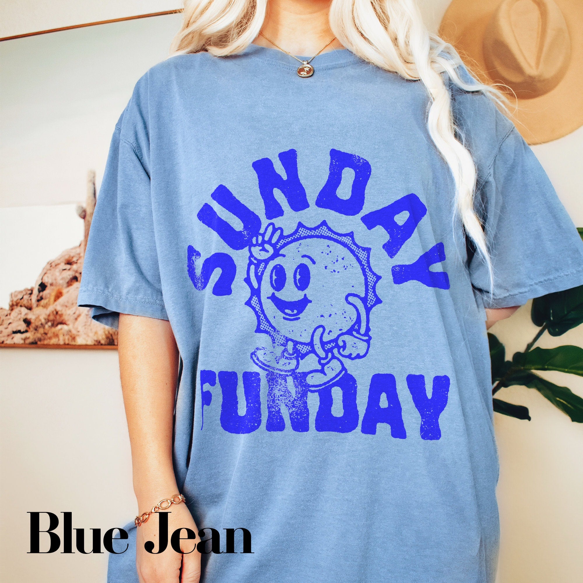 a woman wearing a blue shirt with a cartoon character on it