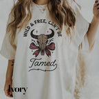 a woman wearing a white shirt with a bull skull on it