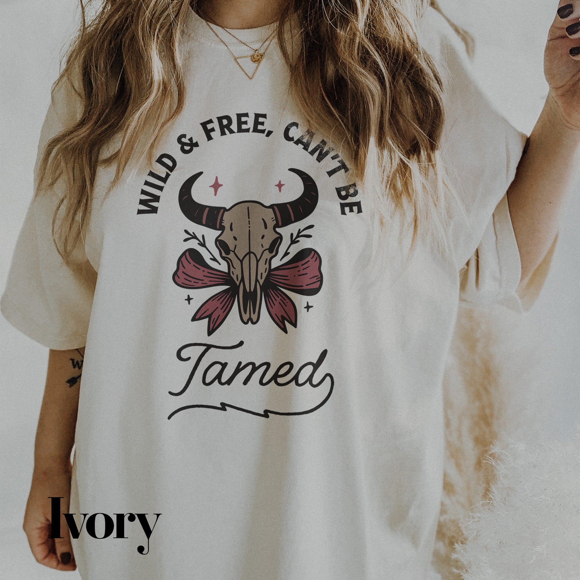 a woman wearing a white shirt with a bull skull on it