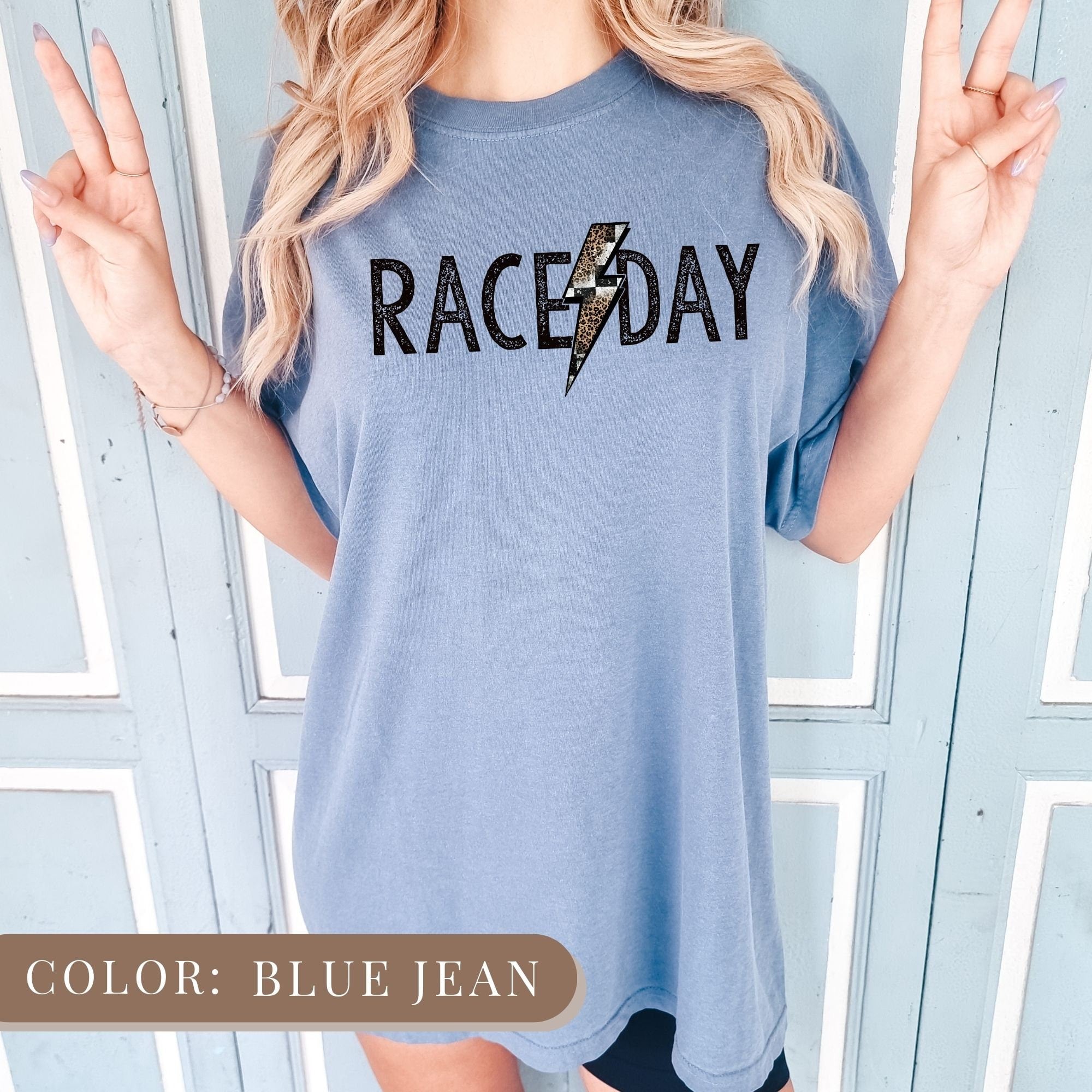 a woman wearing a blue raceday t - shirt