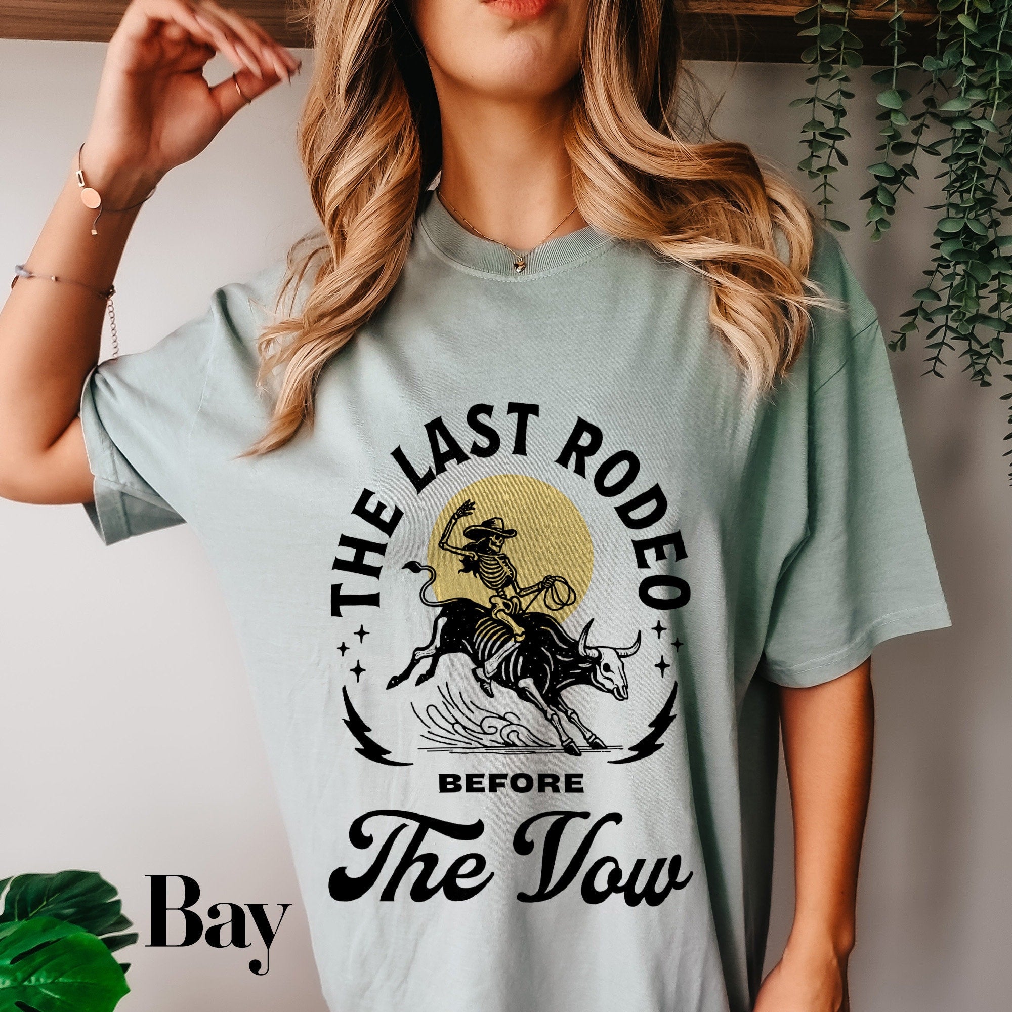 a woman wearing a t - shirt that says the last rodeo before the town