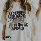 a woman wearing a white shirt with a tiger on it