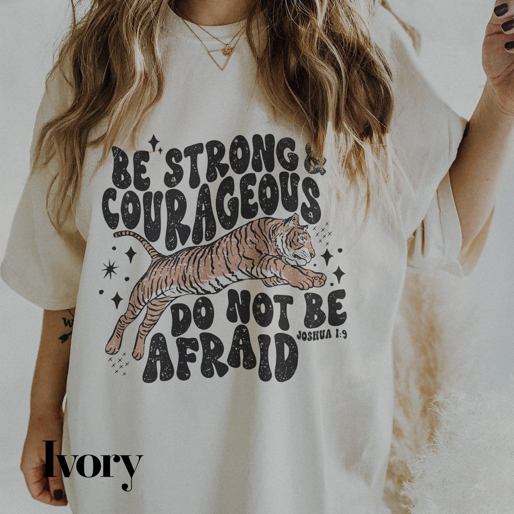 a woman wearing a white shirt with a tiger on it