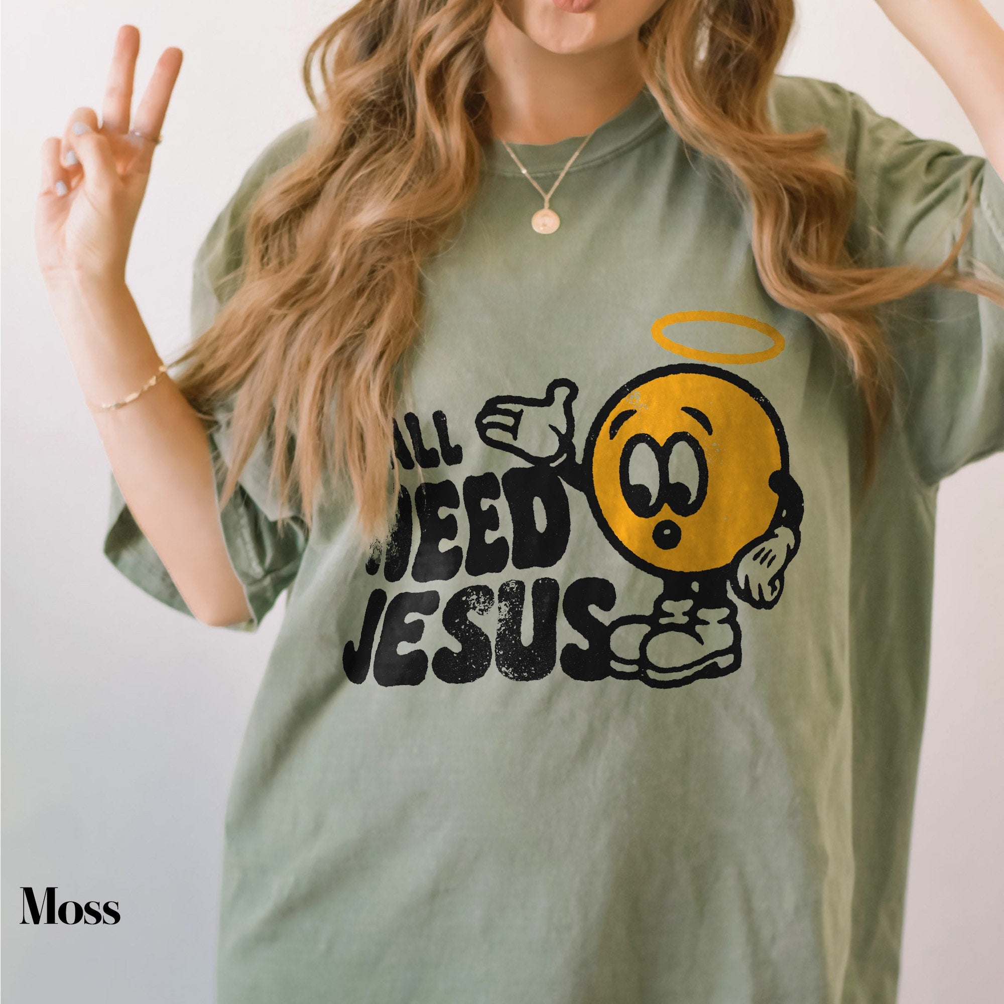 a woman wearing a green shirt with a smiley face on it