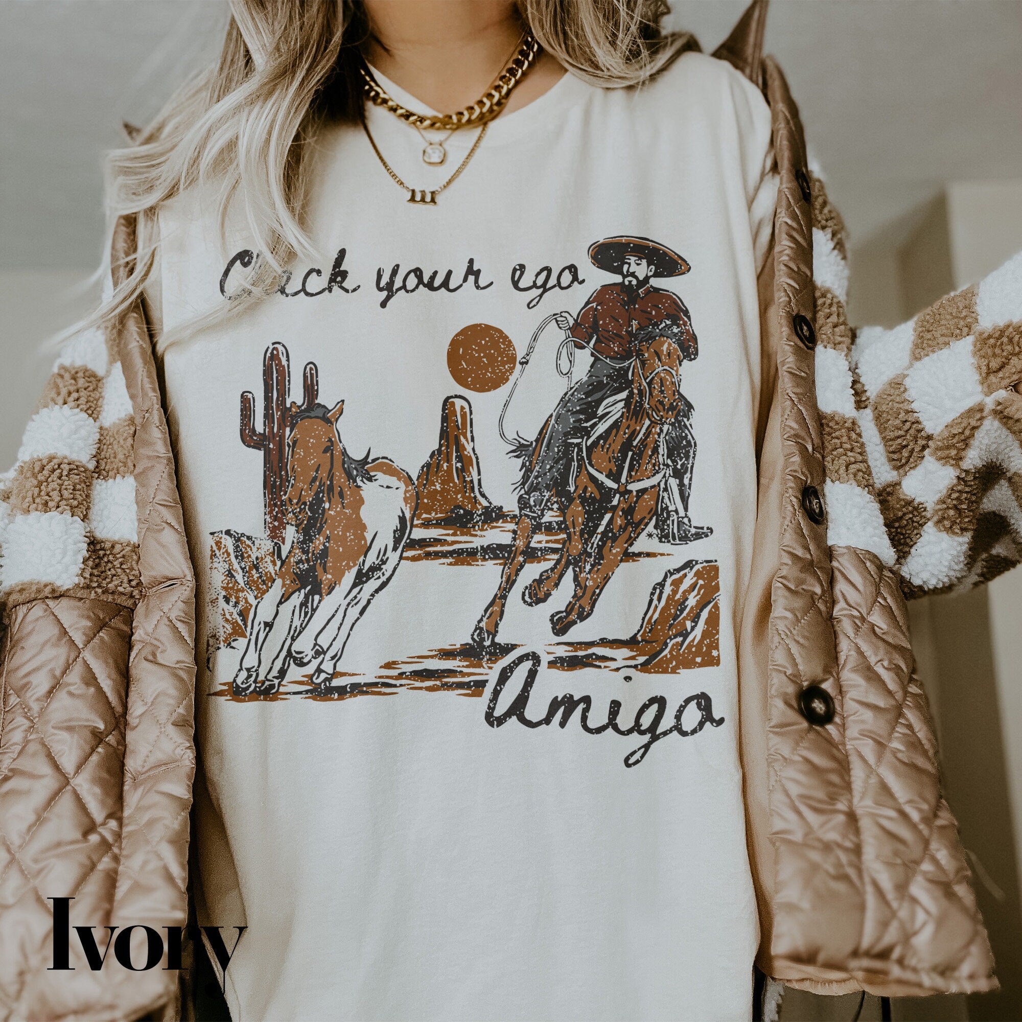 a woman wearing a white shirt with an image of a cowboy riding a horse