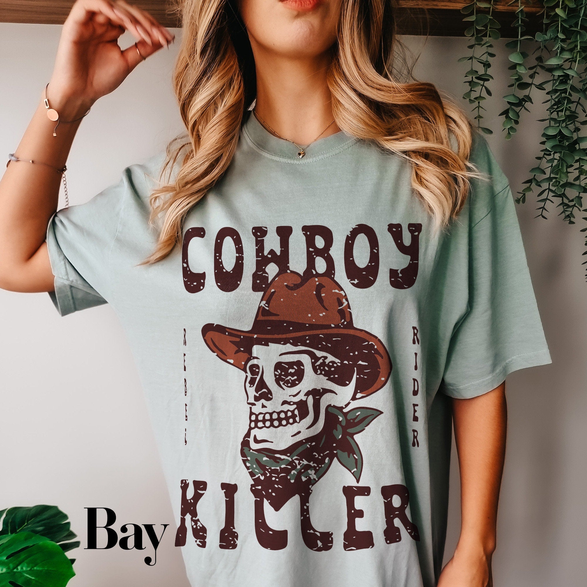a woman wearing a cowboy skull t - shirt
