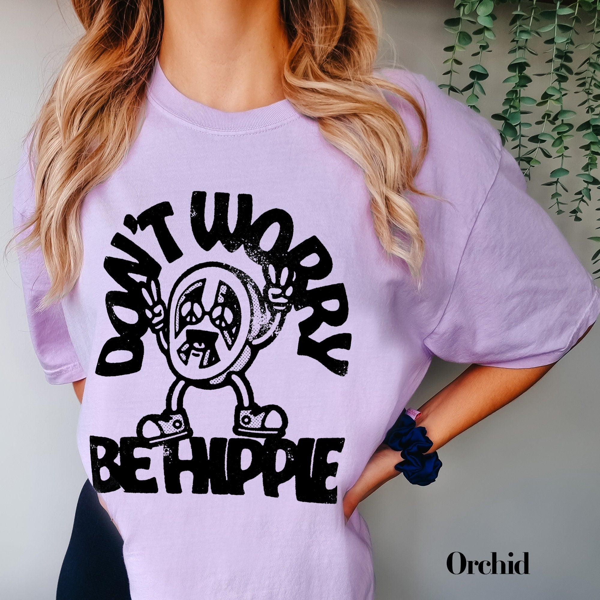 a woman wearing a purple shirt with a cartoon character on it
