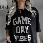 a woman wearing a black game day vibes shirt