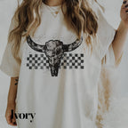 a woman wearing a white shirt with a cow skull on it