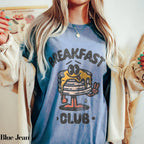 a blonde woman wearing a breakfast club shirt