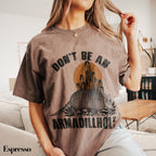 a woman sitting on a couch wearing a t - shirt that says don&#39;t