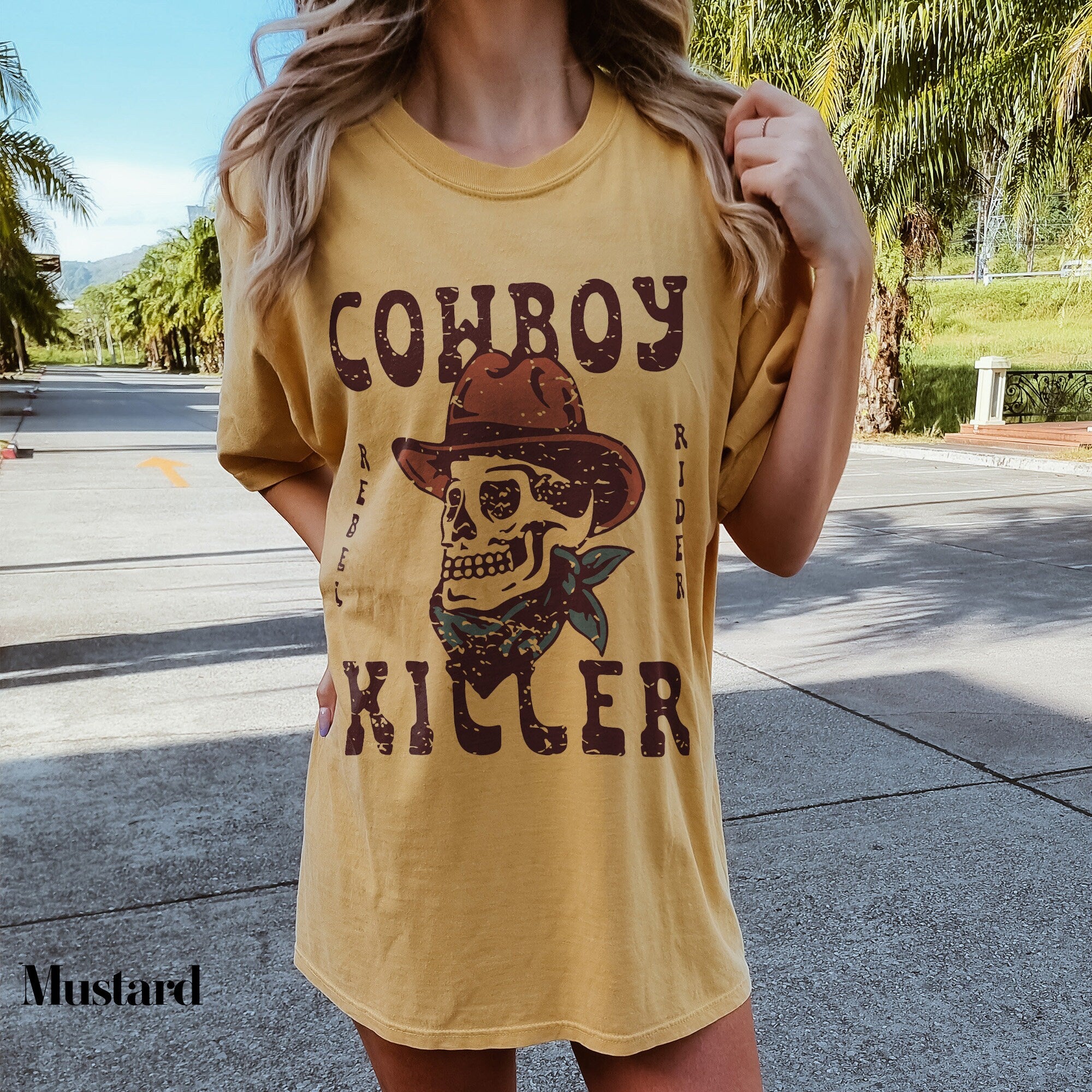 a woman wearing a cowboy skull t - shirt