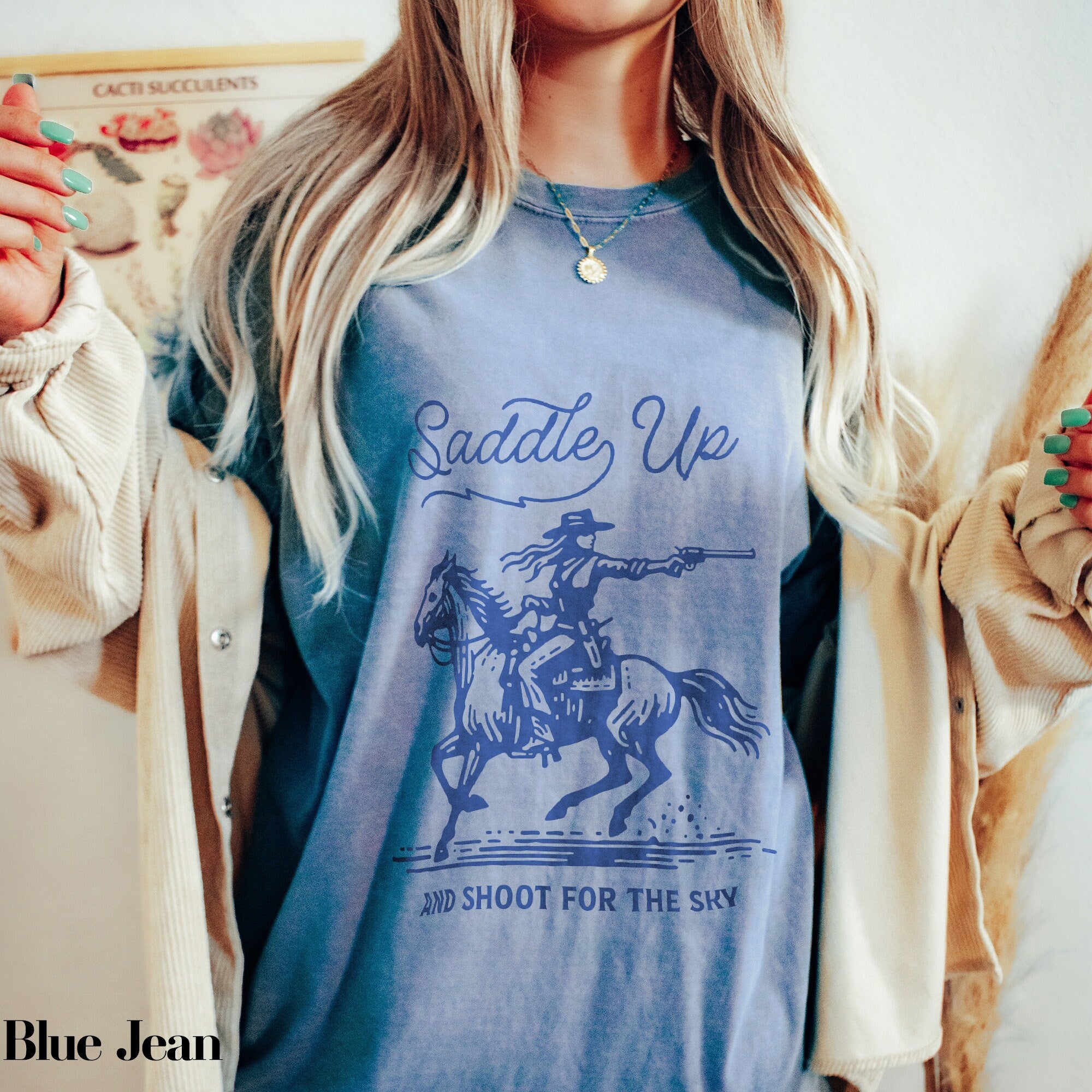 a woman wearing a blue shirt with a picture of a cowboy on it