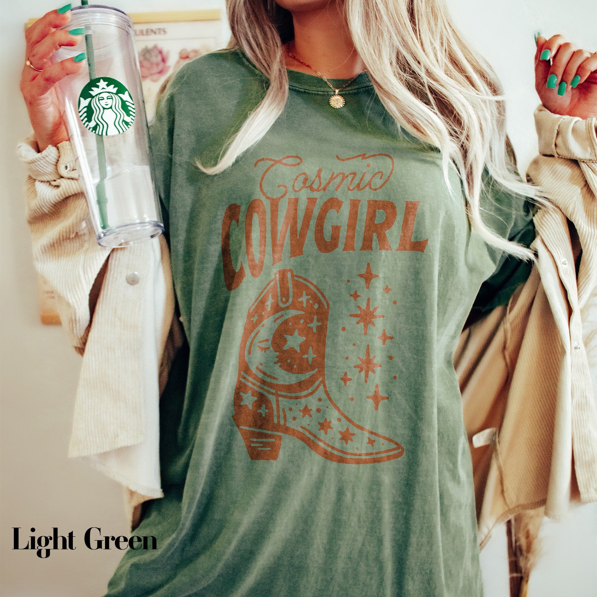 a woman holding a starbucks cup and a starbucks drink